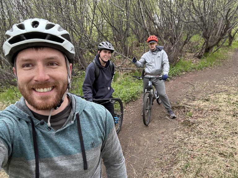 Sam Berdahl biking a trail with a small group