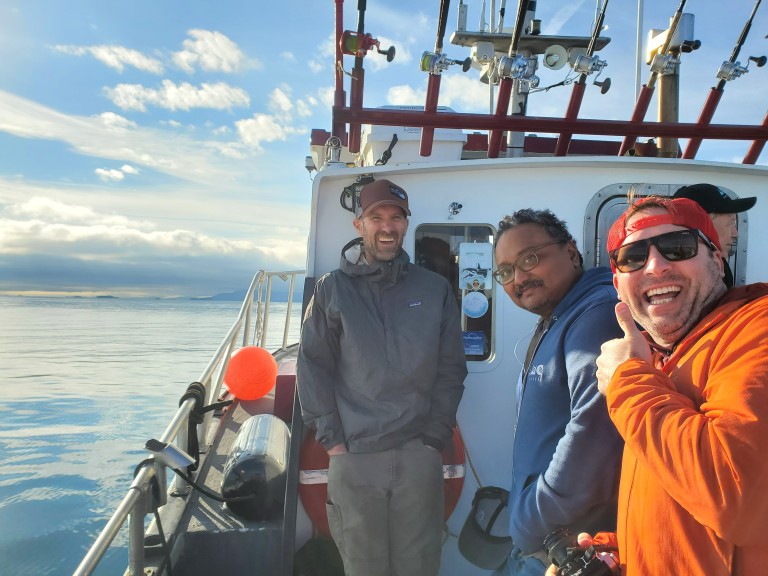 Multiple AMC employees on a fishing boat