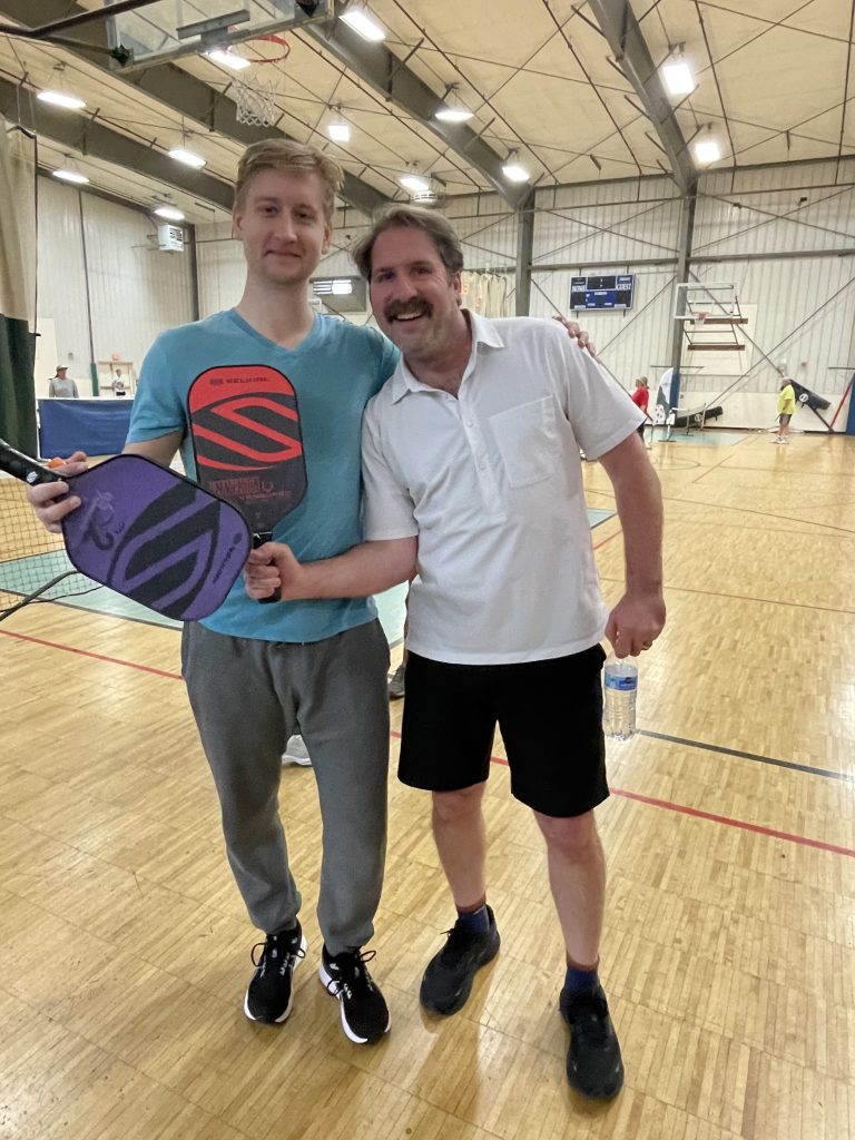 Drew and another AMC employee playing pickleball