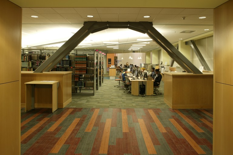 Library archway entrance with shelves and computer tables