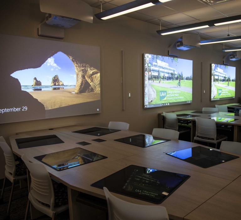 Multiple projects and computer screens in room